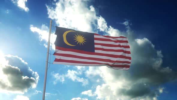 Flag of Malaysia Waving at Wind Against Beautiful Blue Sky