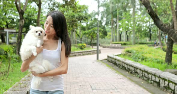 Woman hug dog and walking in the park