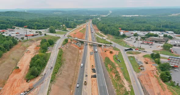 Aerial view construction of road interchange workers heavy machinery