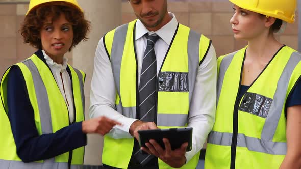 Architects discussing over digital tablet 4k