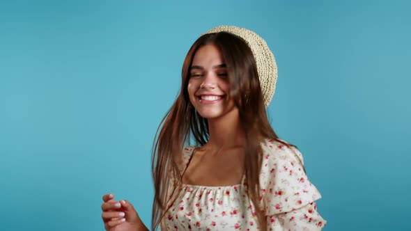 Beautiful Woman with Beautiful Hair Funny Dancing on Blue Studio Background. Cute Girls Portrait