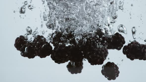 Slow motion shot of blackberries splashing into water, shot with Phantom Flex 4K camera.