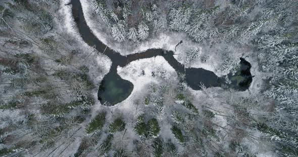 Spring Water Lakes and River in Winter in Forest Aerial Top Down View Rotating