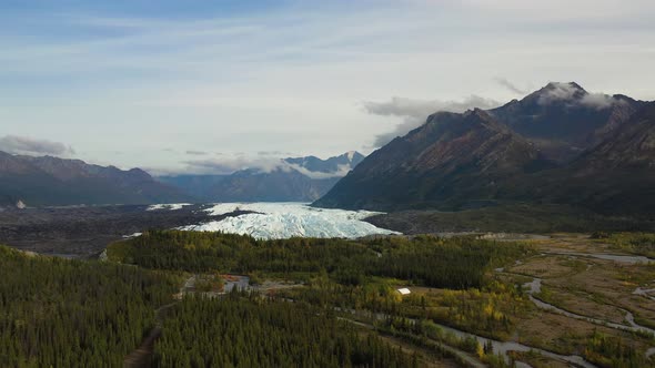 Aerial slide: Brooks Range mountains valley with dense spruce forests and multibranch streams formed