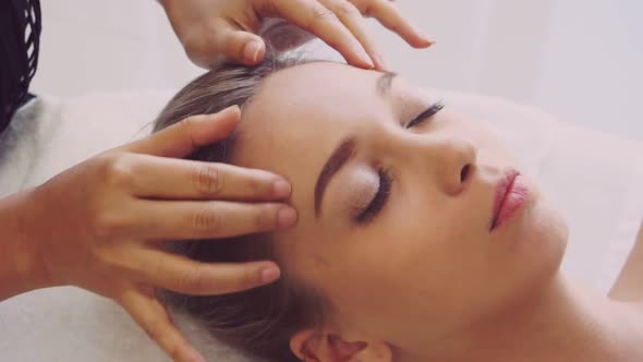 Woman Gets Facial and Head Massage in Luxury Spa