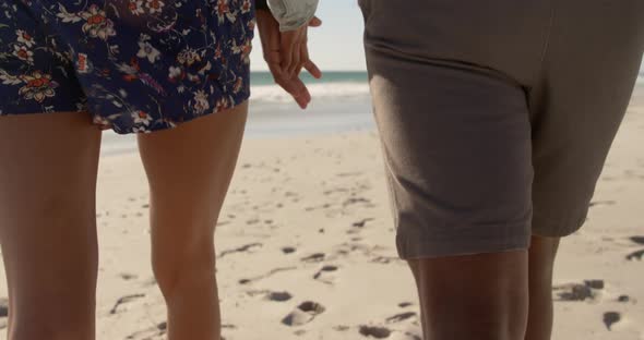 Couple walking together on the beach 4k