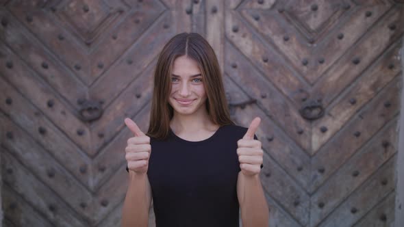 Thumbs Up. Ok. Girl Turns To the Camera. Laughing Child. Closeup