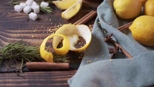 Still life with lemons and cinnamon with honey on wooden table, top view