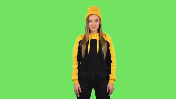 Modern Girl in Yellow Hat Is Smiling. Green Screen