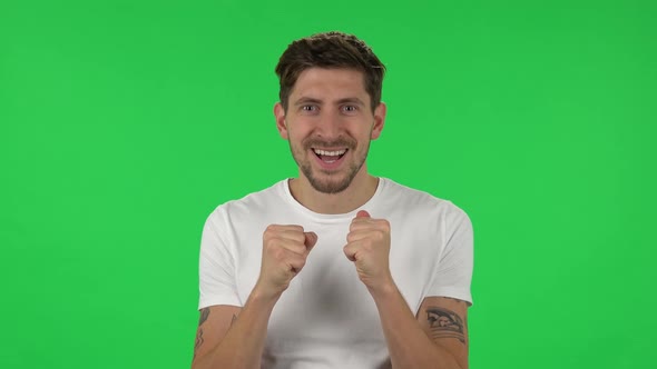 Portrait of Confident Guy Is Looking at the Camera with Excitement, Then Celebrating His Victory