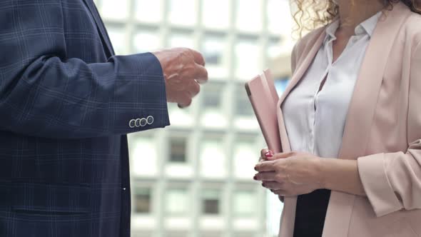 Two Business People a Man and a Woman are Emotionally Talking in the Courtyard of the Business