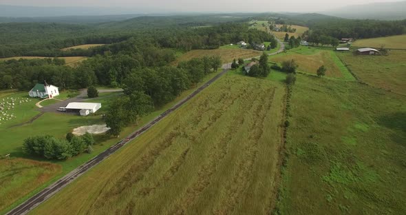 Aerial views of family bicycling along pastoral country roads.