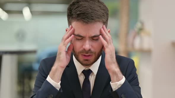 Exhausted Young Businessman Having Headache