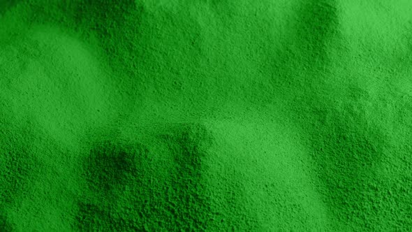 Powdered Green Material Rotating Slowly