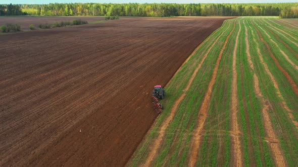 Tractor Plowing Rural Field In Spring Season