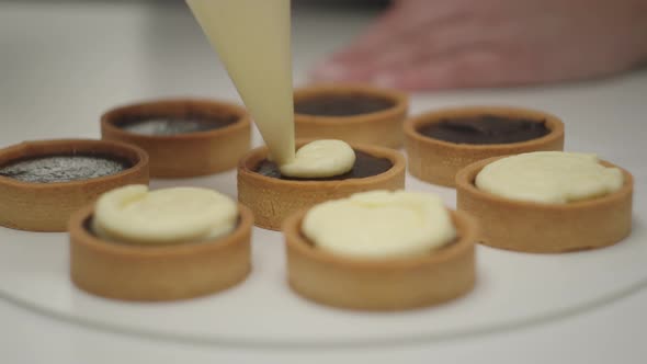 Filling Blueberry Tarts with Cream with Party Bag in Slow Motion