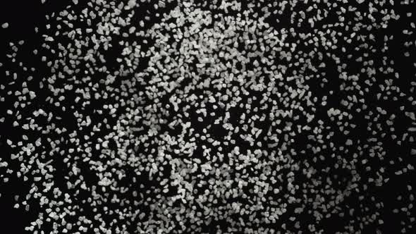 4K 30fps, White particles fly after being exploded against black background, Slow Motion