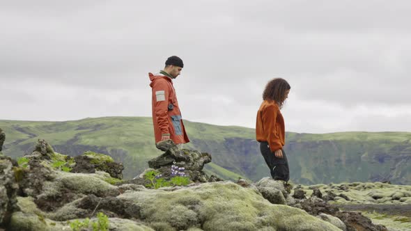 Young Couple Hiking Over Moss And Rocks