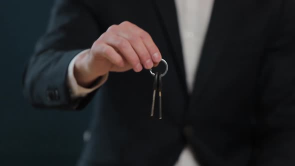 Slow Motion of Male's Midsection in Formal Jacket Holding House Keys in Hand and Showing To Camera