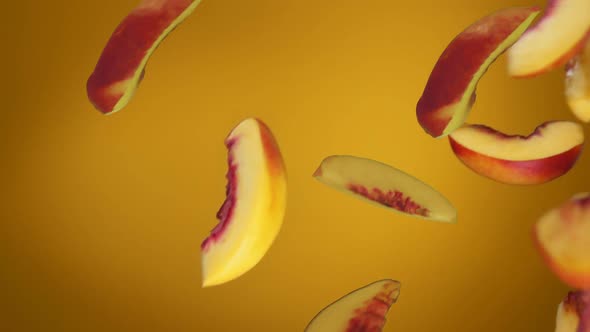 Fresh Ripe Peach Slices are Falling Diagonally on the Yellow Background