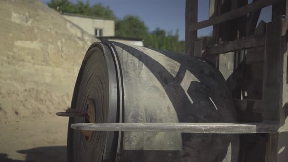 Loader Putting Rolled Conveyor Belt on Ground and Leaving. Process of Cement Production on