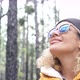 portrait of beautiful woman looking and enjoying nature in a forest with some trees - traveling - VideoHive Item for Sale