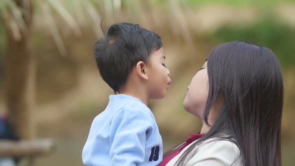 Asian Little Boy Kissing His Mother