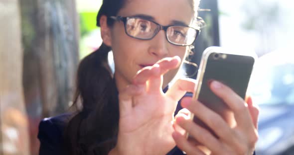 Smiling businesswoman using mobile phone