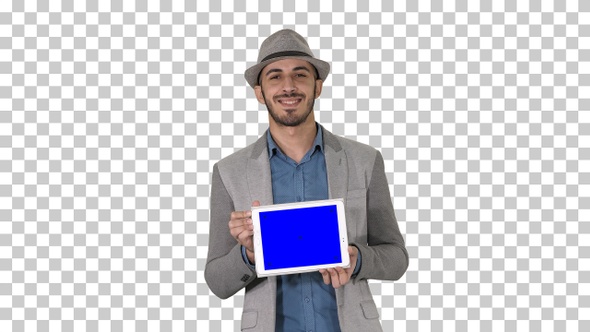Casual man in a hat walking and showing digital tablet