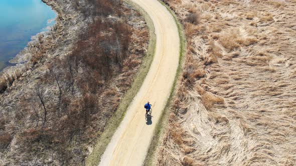 Aerial Iew Cyclist Is Engaged in a Healthy Lifestyle. Bike Ride in the Park. A Quadrocopter That