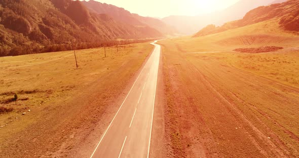 Flight Over Mountain Asphalt Highway Road and Meadow