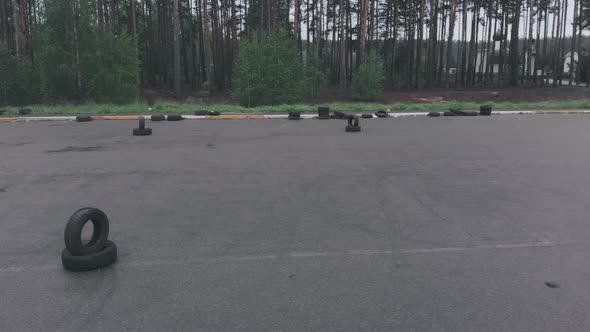 Empty asphalt autodrome with road markings and tires. Driving lessons training at car parking