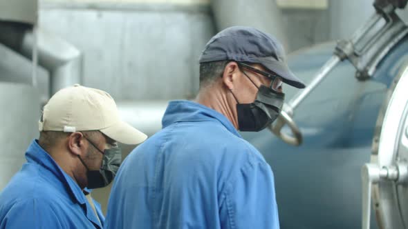 Slow Motion of Male Laborers Working at Factory