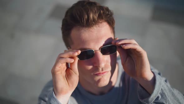 Portrait Handsome Serious Tough Man Dresses His Black Sunglasses and Looks at the Camera