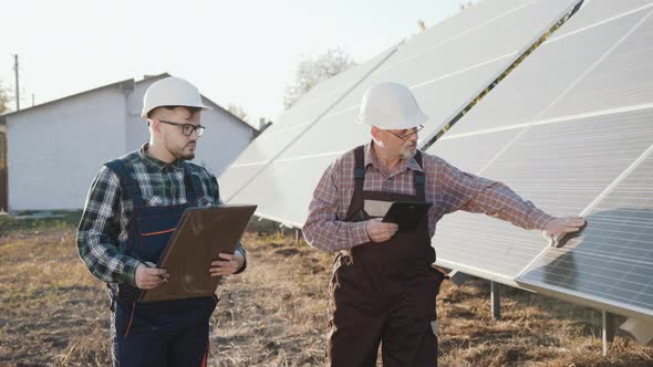 Two Engineers Analyzing Work of Alternative Solar Batteries on a Factory