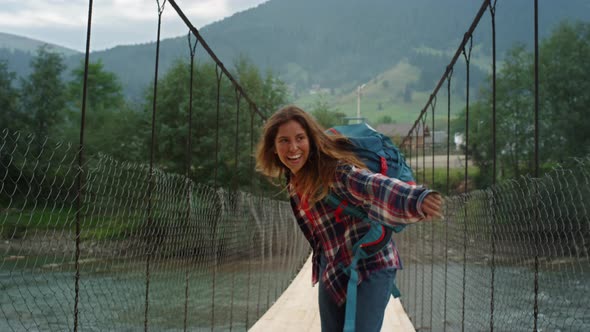 Smiling Girl Hiking Woods on Mountain River Bridge