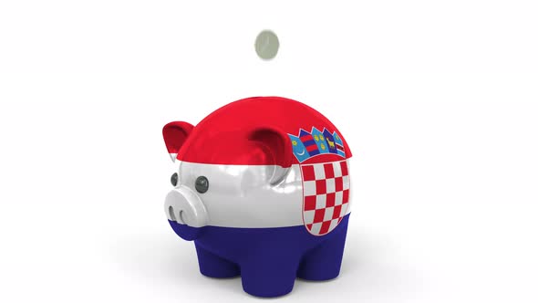 Coins Fall Into Piggy Bank Painted with Flag of Croatia alt