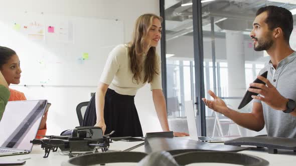 Diverse group of work colleagues brainstorming in meeting room