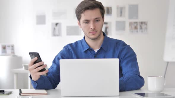 Casual Adult Man Talking on Phone at Work