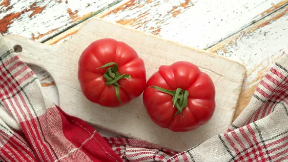 Two Fresh Eco Tomatoes Placed on White Wooden Cutting Board