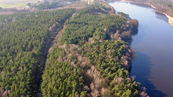 Aerial view from above of forest road and one lake