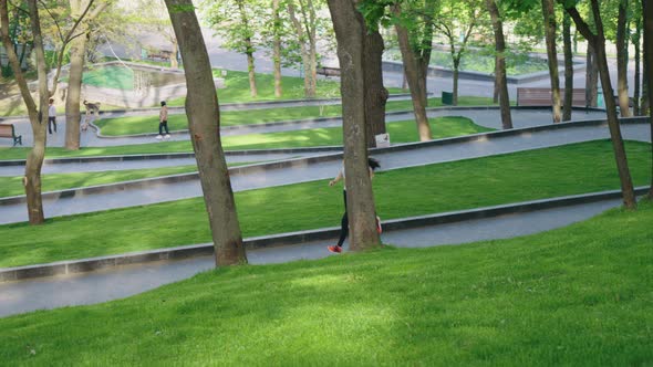 Jogger and Pet Owners in the Morning Park