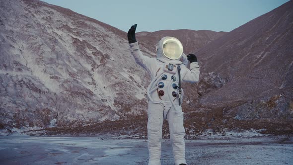 Astronaut with Phone in Hand Talking on Video Chat at the Hills