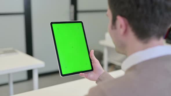 Rear View of Man Using Tablet with Chroma Screen