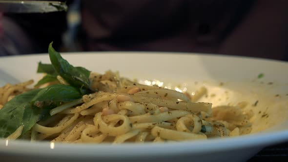 A Man Eats Pasta in a Restaurant - Closeup on the Dish