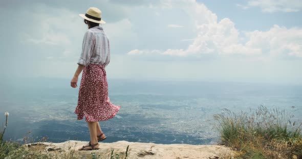 Woman Traveler on Mountain Top Lookig at City From Height of Flying Flight