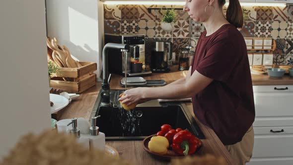 Woman Rinsing Veggies