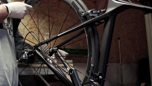 Mechanic Repairing Bicycle in Workshop