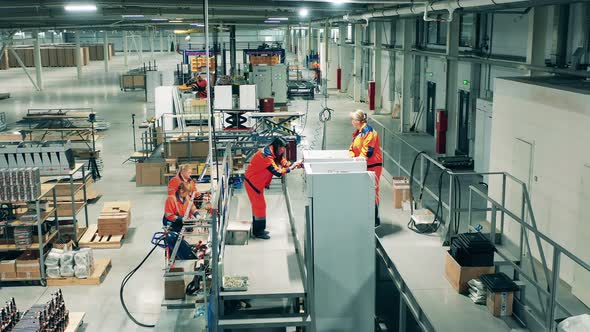 Factory Technicians Are Manually Assembling Refrigerators