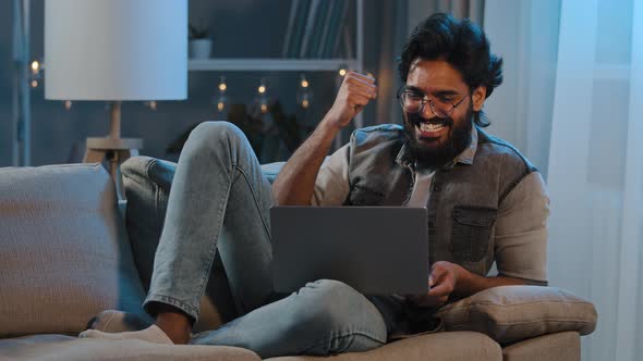 Excited Arabian Indian Bearded Man Winner Look at Laptop Celebrate Success Online Victory Get Great